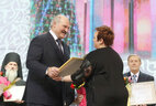 Александр Лукашенко вручает награду редактору АТН Елене Бормотовой