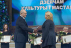 Александр Лукашенко вручает награду директору Наталье Шарангович