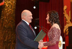 Olga Medvedeva, an editor at the Zvyazda newspaper, receives a letter of commendation from the Belarusian President