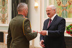 Aleksandr Lukashenko presents general’s shoulder boards to deputy commander of troops of the Western Operational Command of the Armed Forces of Belarus Igor Demidenko