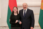 Belarus President Aleksandr Lukashenko presents a passport to student of Cherven secondary school No. 4 Viktoriya Vorobei