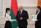 Belarus President Aleksandr Lukashenko presents a passport to student of Ostrovets secondary school No. 3 Viktoriya Shlyakhtun