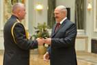 Alexander Lukashenko presents shoulder boards of major general of police to Ivan Podgursky
