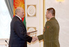 Alexander Lukashenko presents a certificate of professor of military art and construction to deputy head of the General Staff of the Armed Forces of the Republic of Belarus Nikolai Buzin