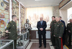Belarus President Aleksandr Lukashenko tours the military history exhibition hall at the Military Academy