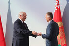Aleksandr Lukashenko was given a symbolic key to the new school, which he handed to Director of school No.93 Oksana Tsimbalenko