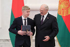 Aleksandr Lukashenko presents a passport to student of Minsk secondary school No. 110 Nikita Savich