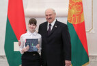 Aleksandr Lukashenko presents a passport to student of Mogilev secondary school No. 5 Viktoriya Khotyaintseva