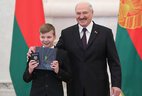 Aleksandr Lukashenko presents a passport to student of Zelva secondary school No. 3 Aleksandr Yanushchenko