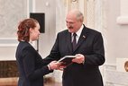 Aleksandr Lukashenko presents a passport to student of Krasnopolye secondary school Ulyana Batura