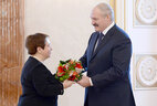Alexander Lukashenko presents the Doctor of Economics diploma to Lyudmila Stefanovich