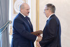 Alexander Lukashenko presents the professor certificate to Alexei Marochkov
