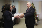 Alexander Lukashenko receives a set of Christmas baubles from journalists
