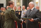 Graduate of the National Security Institute Sergei Drobysh receives a letter of commendation from the President