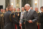 Graduate of the Command and Staff Department of the Military Academy Yuri Drozd receives a letter of commendation from the President
