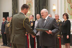 Graduate of the National Security Institute Vladimir Matyushenok receives a letter of commendation from the President