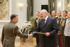 Graduate of the command department of the Command and Engineering Institute of the Emergencies Ministry Colonel of Interior Service Yuri Bogdanov receives an official letter of thanks from the President