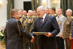 Graduate of the command and staff department of the Military Academy of the Republic of Belarus Colonel Andrei Dunayenko receives an official letter of thanks from the President