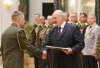 Graduate of the National Security Institute of the Republic of Belarus Captain Sergei Makhovikov receives an official letter of thanks from the President