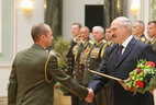 Graduate of the command and staff department of the Military Academy of the Republic of Belarus Lieutenant Colonel Denis Studnev receives an official letter of thanks from the President