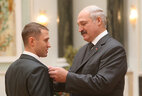 Athlete and coach of the Belarusian national trampoline team Nikolai Kazak receives the Honored Master of Sport of Belarus title