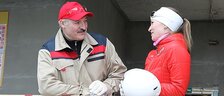 Alexander Lukashenko works at the construction site together with Olympic champion Darya Domracheva, 12 April 2014