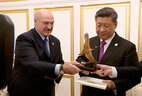 Belarus President Aleksandr Lukashenko and China President Xi Jinping exchange presents