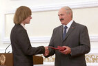 Alexander Lukashenko presents a certificate of the Belarus President special fund for supporting talented youth to student of the Belarusian State University Sergei Kulik who won a gold medal at the 25th International Olympiad in Informatics