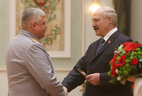 Alexander Lukashenko presents shoulder boards of major general of justice to Oleg Sharkov
