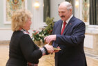 The President gives an official letter of thanks to director of the Rogachev social service center Tamara Drobyshevskaya