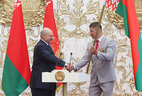 Alexander Lukashenko gives the national flag of the Republic of Belarus to Olympic Canoeing Champion Alexander Bogdanovich, the captain of Belarus’ Rio 2016 team