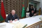 Alexander Lukashenko and Gurbanguly Berdimuhamedow leave messages in the Book of Distinguished Guests of the factory