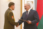 Alexander Lukashenko presents a diploma of the doctor of medical sciences to deputy head for educational and scientific work of the military medicine department at the Belarusian State Medical University Vasily Bogdan