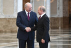 Belarus President Alexander Lukashenko welcomes Russia President Vladimir Putin at the Palace of Independence
