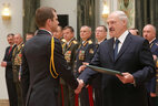Graduate of the Academy of the Interior Ministry of Belarus Alexander Garus receives a letter of commendation from the President