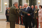 Graduate of the Command and Staff Department of the Military Academy Andrei Kravchenko receives a letter of commendation from the President