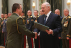 Graduate of the National Security Institute Sergei Sulimov receives a letter of commendation from the President