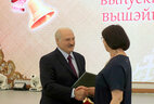 Tatyana Tsybulskaya, the head of the voice department at the Belarusian State Academy of Music, receives a commendation letter from the President