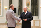 Aleksandr Lukashenko presents shoulder boards of major general of justice to colonel of justice Pavel Ignatov
