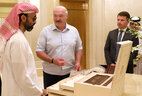 Belarus President Aleksandr Lukashenko presents a Slutsk belt replica and an exclusive assortment of chocolate to Sheikh Tahnoun bin Zayed Al Nahyan