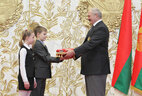 Alexander Lukashenko hands over the flag to students of the specialized Olympic reserve school that offers training in acrobatics and freestyle skiing to children and the youth. Later on the flag will be placed in the Olympic Glory Museum