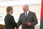 Alexander Lukashenko presents a certificate of the Belarus President special fund for supporting talented youth to student of the Brest State University Alexander Ryzhov who won a gold medal at the 11th International Open Competition in Web Design and Computer Graphics