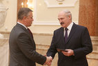 Alexander Lukashenko presents the diploma of the NASB academician to director of the NASB Institute of Heat and Mass Transfer Oleg Penyazkov