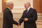 Alexander Lukashenko presents the diploma of the NASB member to deputy academic secretary of the NASB Department for Physics, Mathematics and Informatics Sergei Tikhomirov