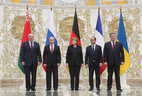 The leaders of the “Normandy four” come out for an official photo session after roughly two hours of talks. Belarus President Alexander Lukashenko also took part in the official photo session