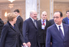 The leaders of the Normandy Four leave the Palace of Independence after the long negotiations in Minsk. Belarus President Alexander Lukashenko talks to the heads of state after the summit