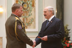 Alexander Lukashenko presents shoulder boards of major general of interior service to Alexander Khudoleyev