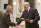 The official letter of thanks from the President of Belarus is presented to first deputy chairman of the Oktyabrsky District veterans' organization of Minsk of the Belarusian Public Association of Veterans Alexei Detsik