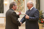 BelTA correspondent Vyacheslav Dutov receives a lapel badge of the Honored Figure of Culture of Belarus