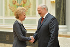 Alexander Lukashenko presents the Medal for Excellent Labor to deputy head of the main department for ideology, culture, and youth affairs the Vitebsk Oblast Executive Committee Larisa Olenskaya